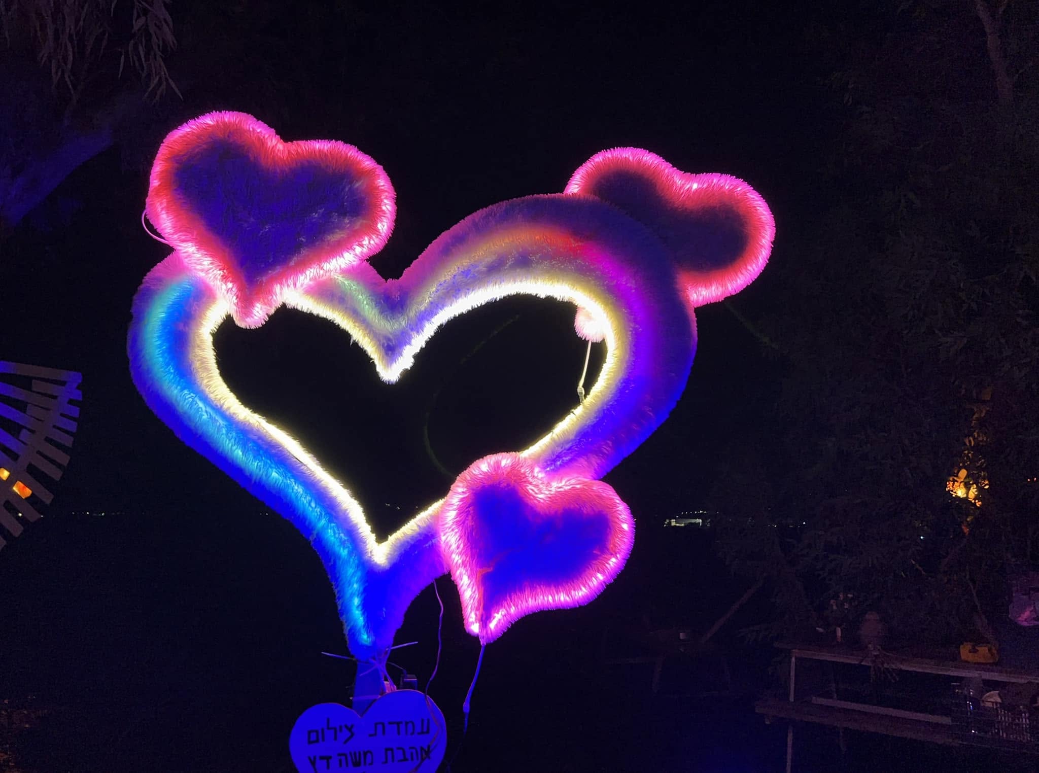 Pink and yellow neon hearts glow in the dark.